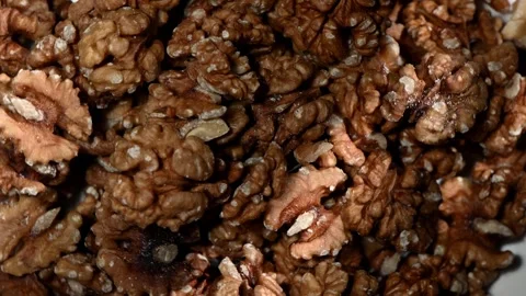 Walnut Halves Spinning on Dark Surface. Top-Down Seamless Motion Loop, Brain Stock Footage 325740907