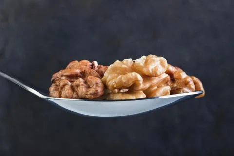 Walnut in iron laid on a dark background Stock Photos