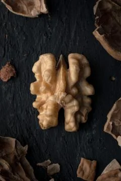 Walnut Kernel On Black Wood Stock Photos