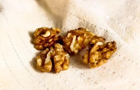 Walnut kernel halves on a light background. Stock Photos