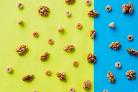 Walnut kernel pattern backdrop. One open nut shell with kernel on yellow blue Stock Photos