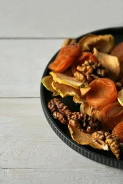 Walnut kernels and apple chips on a plate Stock Photos