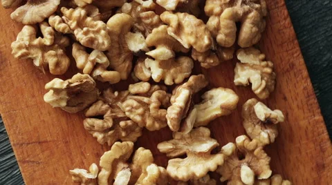 Walnut kernels and on rustic wooden table. Dark and moody style Stock Footage 62738379