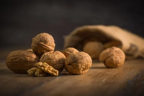 Walnut kernels and whole walnuts on rustic old oak table 写真素材