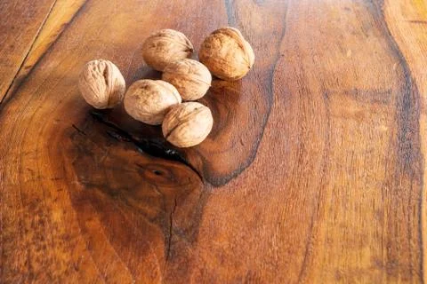 Walnut kernels and whole walnuts on rustic old wooden table, Tasty walnuts on Stock Photos