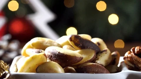 Walnut kernels, brazilian nut and almonds in a bowl on rustic old wooden tabl Stock Footage 83552727