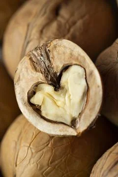 Walnut kernels close up. Half of a walnut in the shape of a heart. Stock Photos