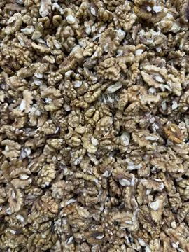 Walnut kernels closely packed together creating textured nut background Фото