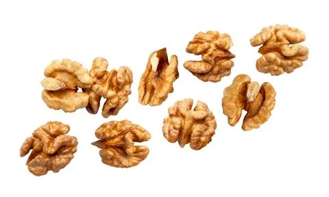 Walnut kernels flying close up on a white. Isolated Stock Photos