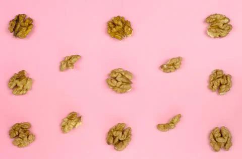 Walnut kernels on a pink background. Walnut pattern Stock Photos