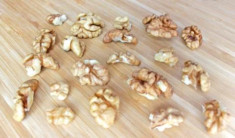 Walnut kernels in the shape of a rectangle on a wooden board Stock Photos