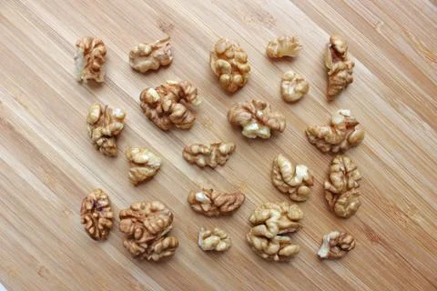 Walnut kernels in the shape of a rectangle on a wooden kitchen board Stock Photos