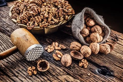 Walnut kernels whole walnuts in burlap sack and vintage bowl Stock Photos