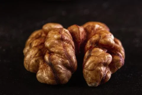 Walnut peeled close-up on dark background Stock Photos
