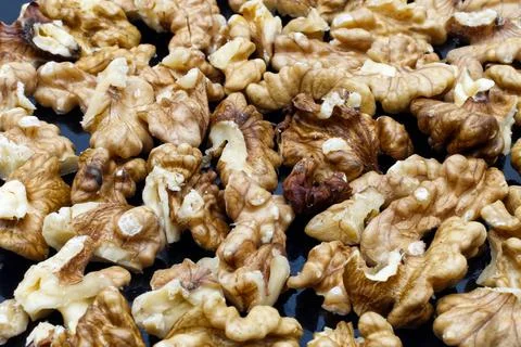 Walnut pile out its shell. Food background. Walnut kernels close up Stock Photos