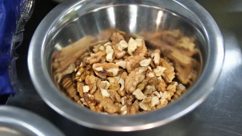 Walnut in a plate on iron table Stock Footage 284434269