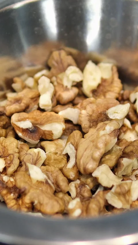 Walnut in a plate on iron table Stock Footage 284439422