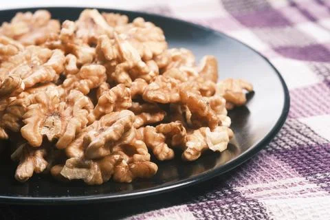 Walnut on a plate on table , close up. Stock Photos