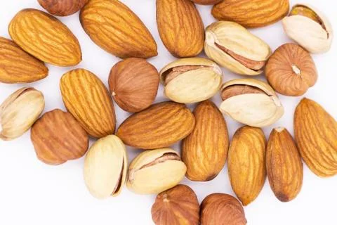 Walnut platter. A bunch of different nuts on a white background-pistachios, a Stock Photos