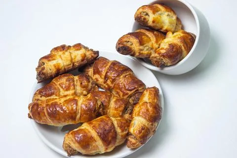 Walnut rolls on a plate on a white background. Homemade baking. Stock Photos