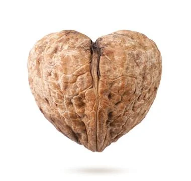 Walnut in the shape of a heart close-up on a white background, levitating and Stock Photos