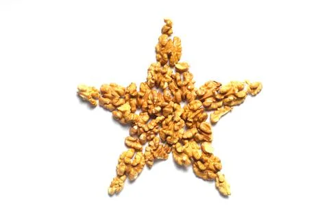 Walnut in the shape of a star on a white background. Stock Photos