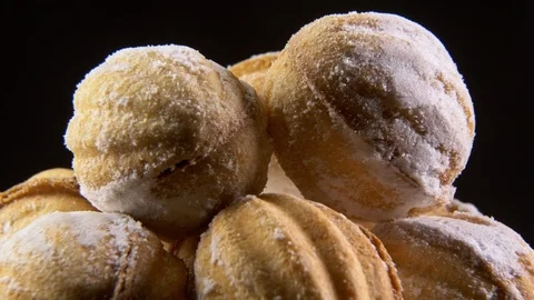 Walnut shaped cookies rotating on black background Stock Footage 122257019