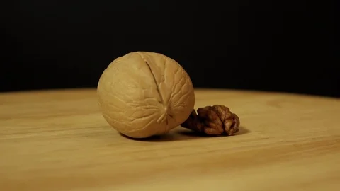 Walnut in shell and without shell rotates 360 degrees on the platform Stock Footage 119666859