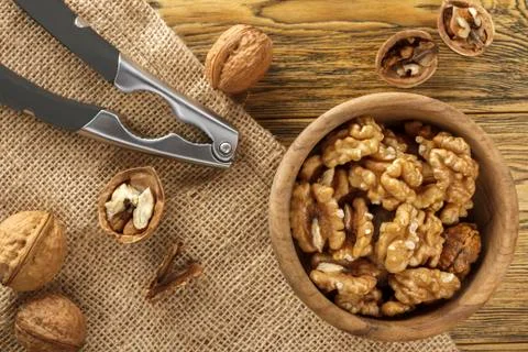 Walnut, shell cleaning process. Natural product on a wooden table. Rustic sty Stock Photos