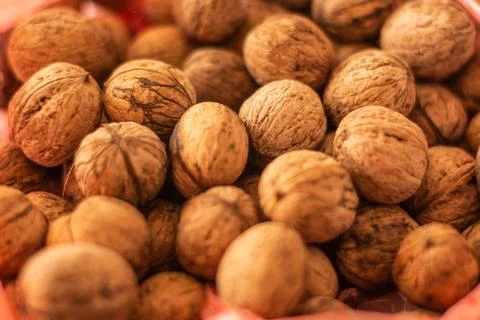 Walnut shells closeup, rustic harvest food backdrop Stock Photos