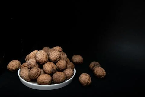 Walnut slide on a black background Stock Photos