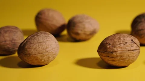 Walnut. Walnuts lie on a yellow background. Stock Footage 124816050