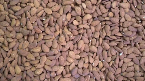 Walnuts and almonds. A close-up of almond kernels and walnuts in shell in a shop Stock Footage 253375231