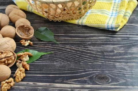 Walnuts and basket on the table Stock Photos