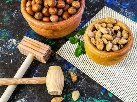 Walnuts and hazelnuts in composition on dark background Stock Photos