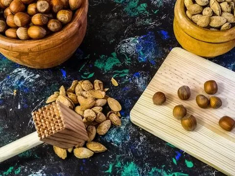 Walnuts and hazelnuts in composition on dark background Stock Photos