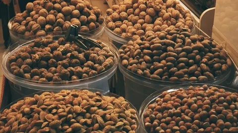 Walnuts and hazelnuts standing in large buckets. Stock Footage 124535416