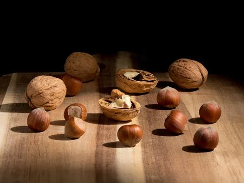 Walnuts and hazelnuts, vanilla pod, subdued background, Christmas wallpaper Stock Photos