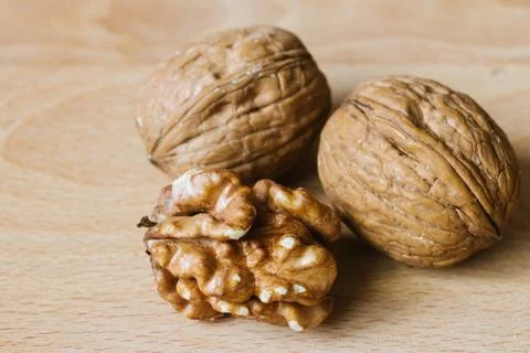 Walnuts and kernel on wooden background Stock Photos