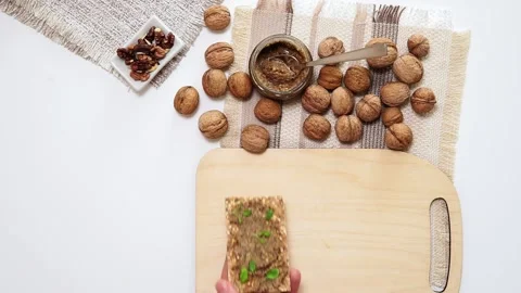 Walnuts and nut butter on bread healthy snacks top view. flat lay Stock Footage 138512790