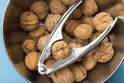 Walnuts and nut cracker Stock Photos