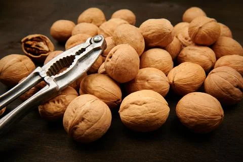 Walnuts and nutcracker close up top view Stock Photos