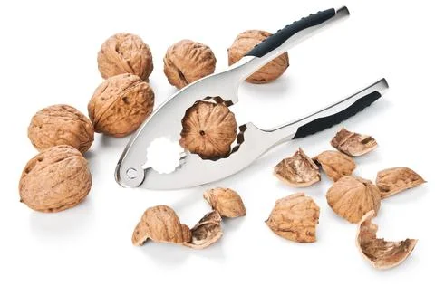 Walnuts and nutcracker isolated on white Stock Photos