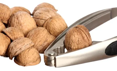 Walnuts and a nutcracker Stock Photos