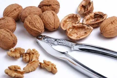 Walnuts and a nutcracker Stockfoto's