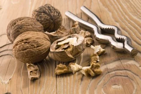 Walnuts and nutcracker Stock Photos