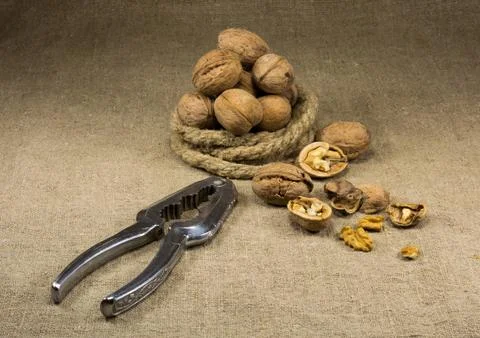 Walnuts and a nutcracker Stock Photos