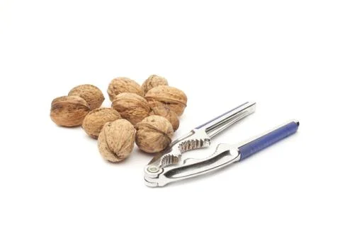Walnuts and nutcracker Stock Photos