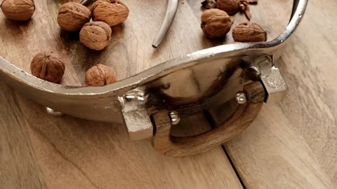 Walnuts and nutcracker in a round silver platter Stock Footage 144067482