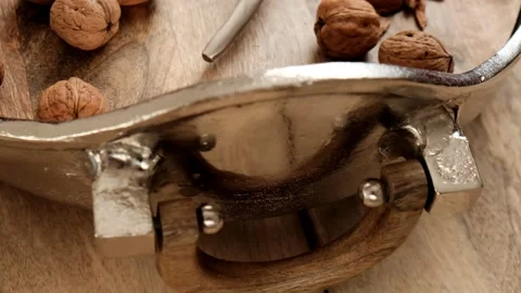 Walnuts and nutcracker in a silver platter. Nutcracker and Nuts.Walnuts close-up Stock Footage 144067944